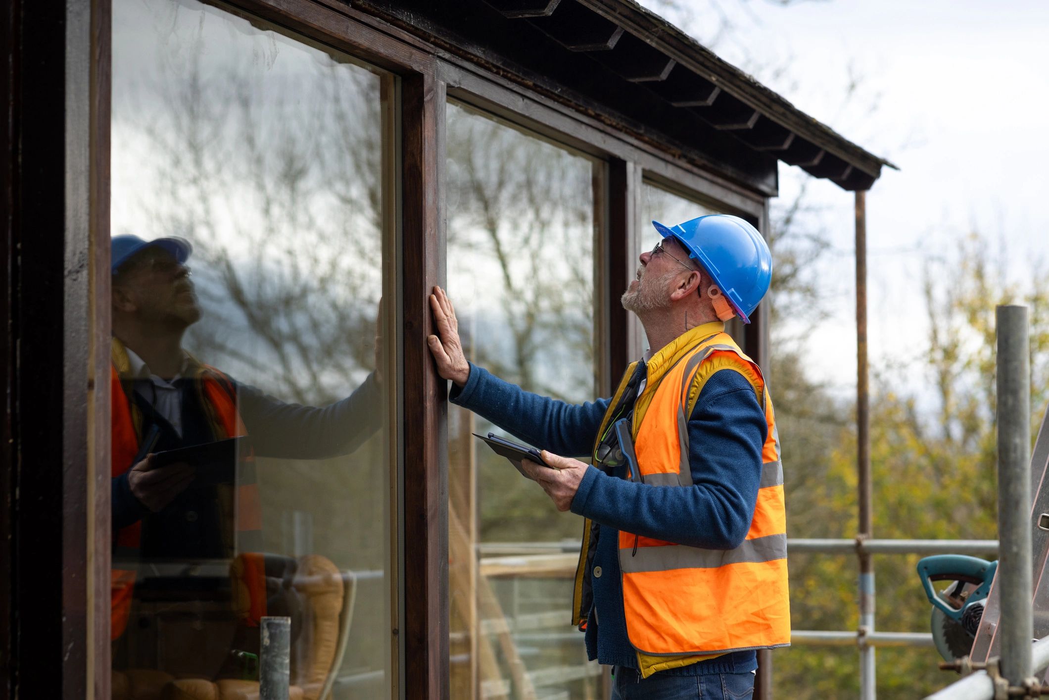Roofing professional inspecting a residential roof for quality and safety.