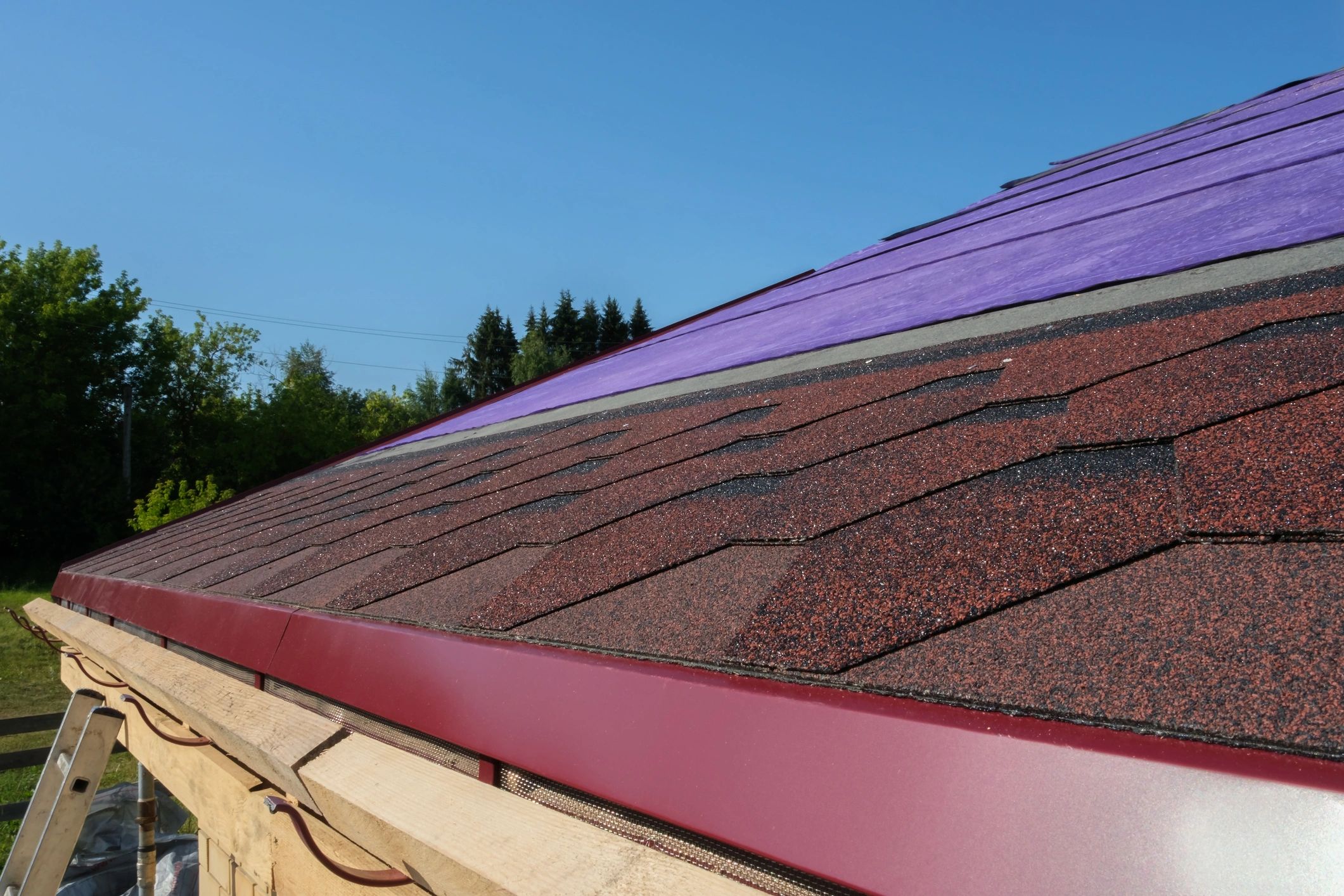Close-up of asphalt shingles during installation